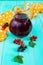 Summer cooling drink - compote of berries black, red currant in a jug on a bright background.