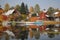 Summer cottages are reflected in the water.