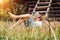 Summer in the countryside - little boy lies near the hayloft