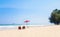 summer couple of Middle-aged 40-50s on the beach vacation holiday relax on their  chairs under a red umbrella.  travel concept at