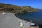 Summer: a cove cliff of cape of the Crosses in Spain with blue sea