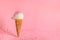 Summer creative concept with ice cream cone and dynamic strewing pink sprinkles on background, festive background for Valentines