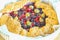 Summer crostata or galette pie with fresh garden berries