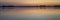 Summer dawn over a calm lake