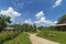 Summer day landscape with road, cloudy sky and Carpathian Mountains