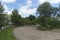 Summer day landscape with road, cloudy sky and small houses. Ukraine, Carpathian.