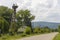 Summer day landscape with road, several storks in nest, cloudy sky and Carpathian Mountains