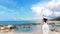 Summer Day. Lifestyle woman wearing white dress fashion summer beach on the sandy ocean beach.