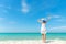 Summer Day. Lifestyle  woman wearing white dress fashion summer beach  on the sandy ocean beach. Happy woman enjoy and relax vacat