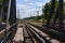 Summer day railway landscape with a view from the railway bridge to the suburban passenger statio