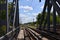 Summer day railway landscape with a view from the railway bridge to the suburban passenger statio