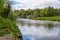 Summer day on the river ribble, Clitheroe. Gentle flowing water and lush green foliage