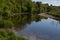 Summer day on the river ribble, Clitheroe. Gentle flowing water and lush green foliage