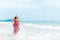 Summer Day. Smiling woman wearing fashion summer beach having fun playing splashing water