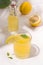 Summer drink fermented kombucha lemonade next to a lemon on a white background.