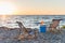 summer drinks on cooler and chaise lounges on sandy beach