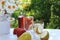 Summer drinks with fruit in the wet open window to the garden. Refreshing pear and peach lemonade with fruits and a vase with