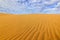 Summer dry landscape in Africa. Black pebble stones. Sandy waves in the wild nature. Dunas Maspalomas, Gran Canaria, Spain.