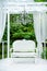 Summer elegant elegant gazebo in the lush gardens. Exquisite classic sofa gazebo