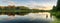 Summer evening landscape on Ural lake with pine trees on the shore, Russia