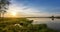 Summer evening landscape on the Ural river with trees on the Bank, Russia, June