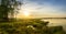 Summer evening landscape on the Ural river with trees on the Bank, Russia, June