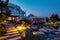 Summer evening view of courtyard near stylish mansion with patio and artificial pond