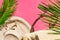 Summer fashion tropical vacation concept. Women`s female beachwear straw hat wicker bag green palm leaves on fuchsia pink