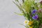 summer field bouquet. chamomile, cornflowers, grass and cereals on a light background with copy space.