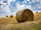 Summer Field with Hay Bales. under storm clouds.Agriculture Concept