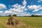 Summer field with mowed grass and haystack,