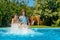 Summer fitness, kids in swimming pool have fun, smiling girls splash in water