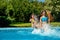 Summer fitness, kids in swimming pool have fun, smiling girls splash in water