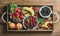 Summer fresh fruit and berry variety in rustic wooden tray