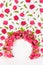 Summer fresh pink roses as framing of circle arch with green leaves and buds soar as pattern on abstract white scene mockup.