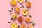 Summer fruit background. Flat lay composition with peaches. Ripe juicy peaches with green leaves on pink background. Flat lay top