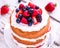 Summer fruit cake with berries and cream