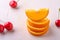 Summer fruit cherries with stacked oranges on white background