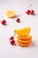 Summer fruit cherries with stacked oranges on white background