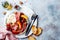 Summer fruit salad with burrata, peaches, figs, grapes and jamon or prosciutto. Top view