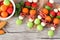 Summer fruit skewers, close up on a wooden background