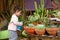 Summer Fun: Little Beautiful Girl Watering Garden.