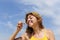 Summer fun: woman blowing soap bubbles outdoors