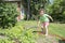 In summer, the garden includes a little girl with a hose tap.