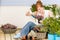 Summer garden terrace redhead woman potted flower