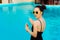 Summer Girl Applying Suncream Lotion by the Pool