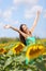 Summer girl happy in sunflower flower field