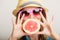 Summer. Girl tourist holding grapefruit citrus fruit