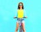 Summer happy smiling young woman rides a bicycle