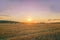 A summer hay field after harvest and large bales of hay